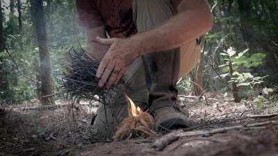 butting kindling onto a fire